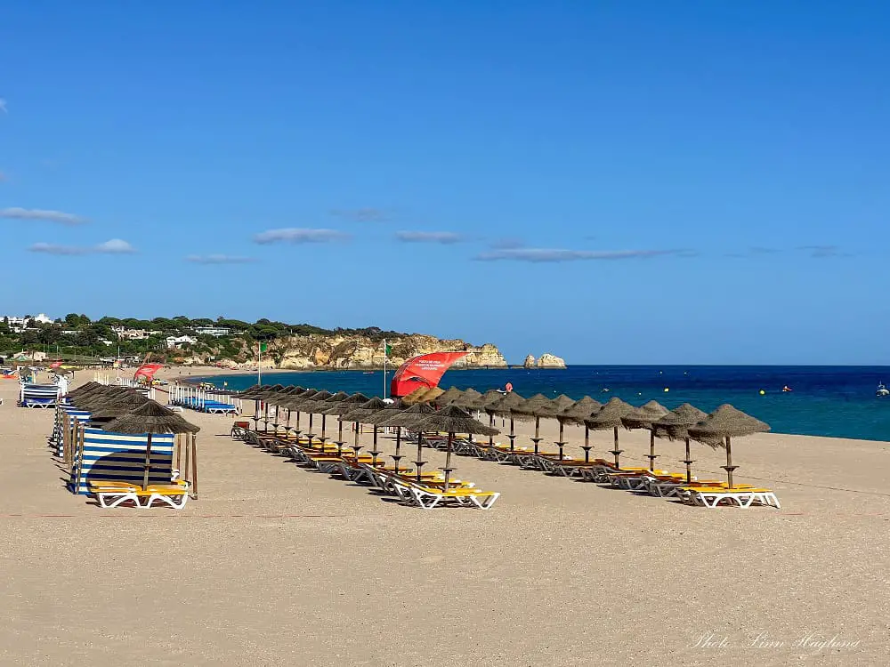 sunbeds and parasols lined up on Alvor Beach.
