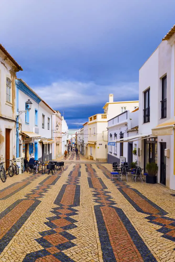 a pedestrian street with restaurants and bars - reasons to visit Lagos Portugal.