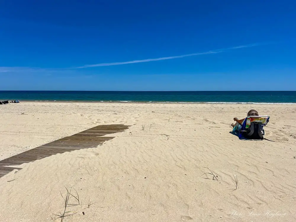 A woman is Sunbathing on Cabanas Beach.