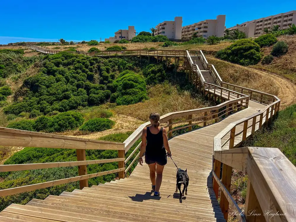 Me and Atlas hiking to Ponta da Piedade on a wooden boardwalk.